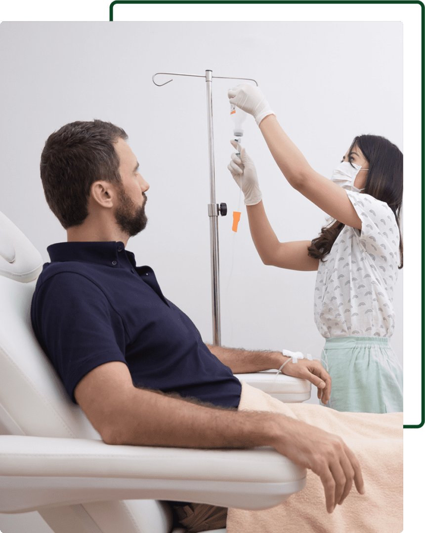 A woman in white gloves is putting an iv into the arm of a man.