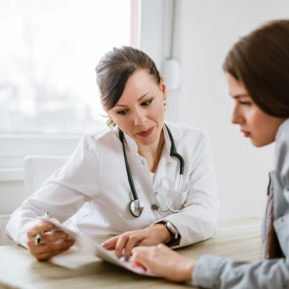 female doctor giving advice to a female patient for supplement plans female doctor giving advice to a female patient for supplement plans